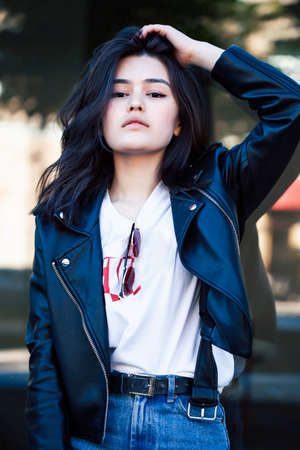 young pretty asian girl outside on big city street, lifestyle people concept