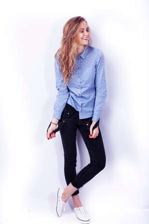 young pretty teenage hipster girl posing emotional happy smiling on white background, lifestyle...