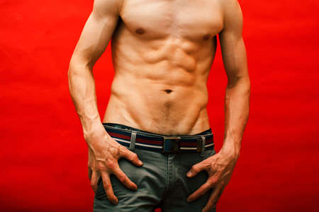 man standing naked torso abc on red background, lifestyle sport peopleの写真素材