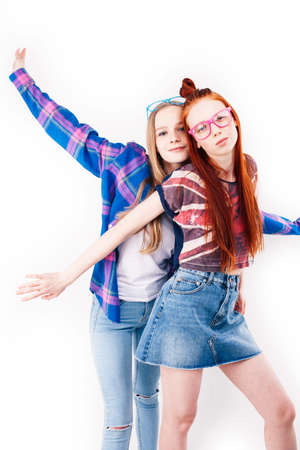 best friends teenage girls together having fun, posing emotional on white background, besties happy smiling, lifestyle people conceptの写真素材