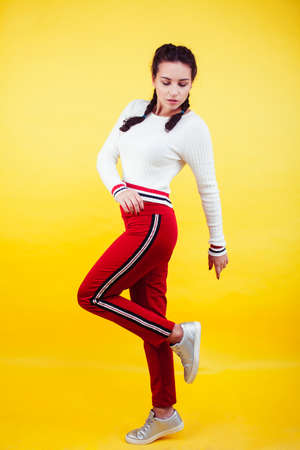 lifestyle people concept: pretty young school teenage girl having fun happy smiling on yellow...