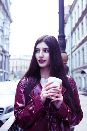 young pretty girl outside in city street with coffee happy smiling, lifestyle fashion peopple...