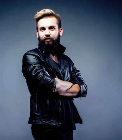 portrait of young bearded hipster guy smiling on gray background close up, lifestyle people concept copyspaceの写真素材