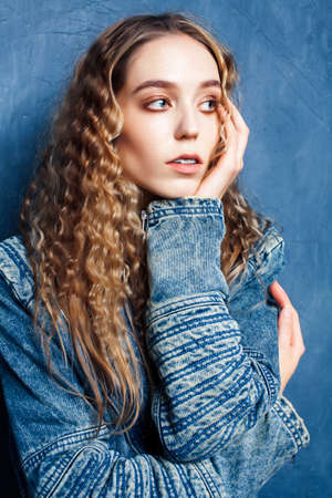 young pretty blond curly girl posing happy smiling on blue background, lifestyle people conceptの写真素材