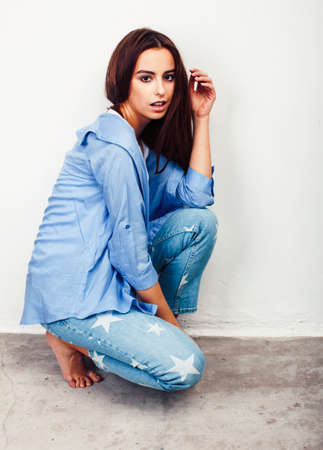 young pretty stylish brunette hipster girl posing emotional isolated on white background happy smiling cool smile, lifestyle people conceptの写真素材