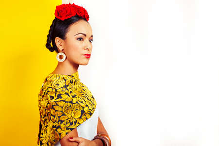 young pretty mexican woman smiling happy on yellow background, lifestyle people conceptの写真素材