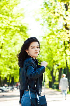 pretty young asian woman smiling cheerful in green park on summer sunny day, lifestyle people conceptの写真素材