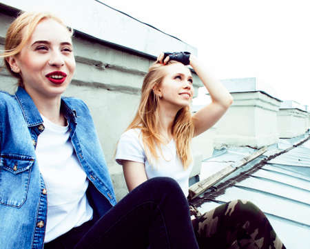 two cool blond real girls friends making selfie on roof top, lifestyle people concept, modern teensの写真素材