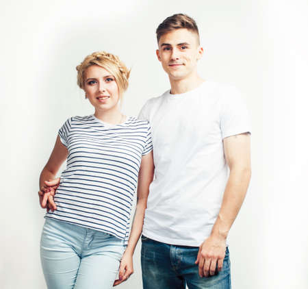 young pretty teenage couple, hipster guy with his girlfriend happy smiling and hugging isolated on...