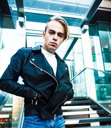 young modern hipster guy at new building university blond fashion handsome boy, lifestyle people...