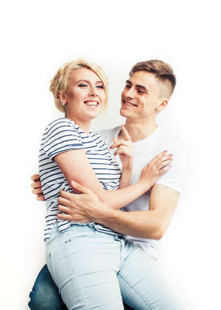 young pretty teenage couple, hipster guy with his girlfriend happy smiling and hugging isolated on...
