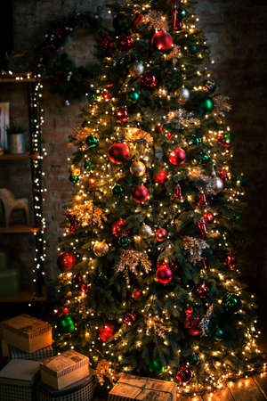 holiday vibe: Christmass tree with red decorated in evening room, holiday conceptの写真素材
