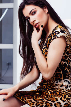 pretty stylish woman in fashion dress with in luxury rich room interior, lifestyle people concept,...