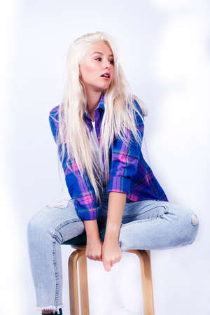 young pretty blond teenage hipster girl posing emotional happy smiling, gesturing isolated on white background, lifestyle poeple conceptの写真素材