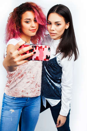 best friends diverse races teenage girls together having fun, asian and african , posing emotional...