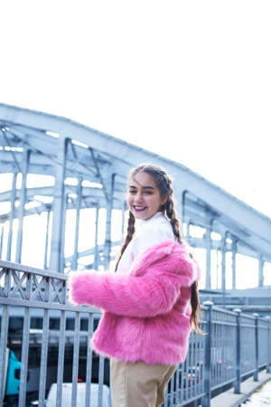 young pretty teenage girl posing cheerful happy smiling wearing street style outside in europe city,...