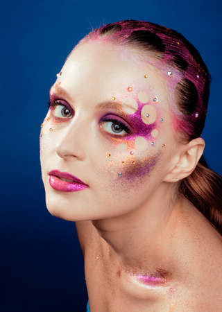 beauty young woman with creative make up, mystery tinselの写真素材