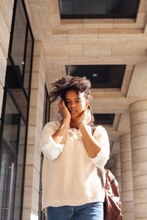 young pretty african girl posing cheerful on city background, lifestyle outdoor people concept