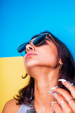 lifestyle people concept. young pretty smiling indian girl with long nails wearing lot of jewelry...