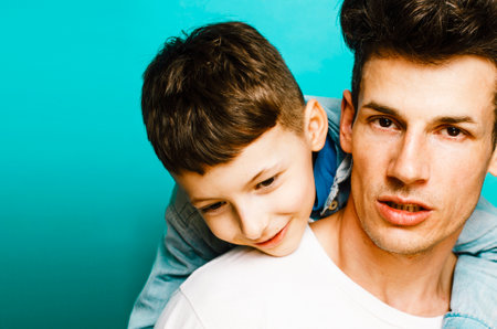 young pretty man model with little cute son playing together, lifestyle modern people concept, family maleの写真素材