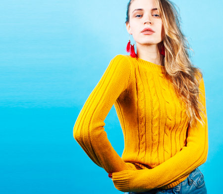 young pretty teenage modern hipster girl posing emotional happy on blue background, lifestyle people conceptの写真素材