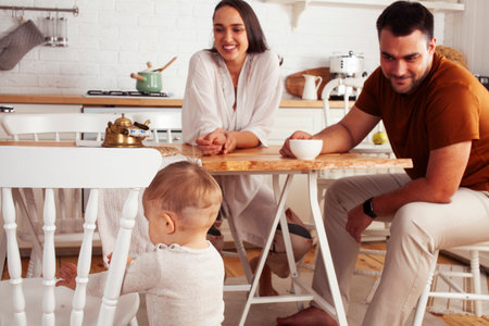 young family with little cute son on kitchen in morning happy smiling, lifestyle people conceptの写真素材