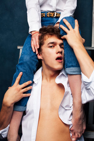 young pretty boy and girl legs on him,relationship concept, lifestyle people conceptの写真素材