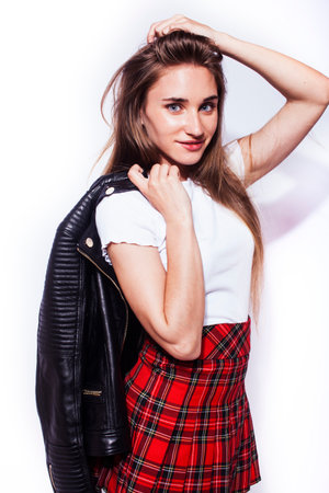 young pretty stylish hipster girl in leather jacket and school shirt posing emotional isolated on white background happy smiling cool smile, lifestyle people conceptの写真素材