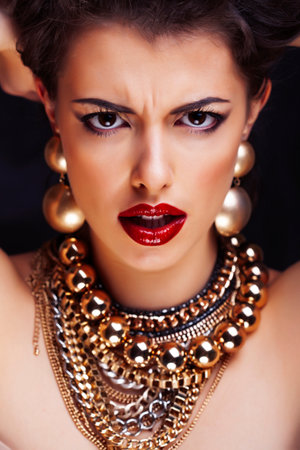 beauty rich brunette woman with a lot of jewellery, hispanic curly lady posing very emotionalの写真素材