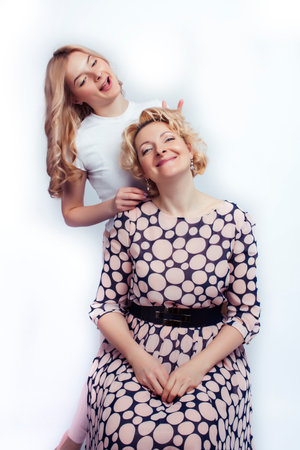 mother with teen daughter together posing happy smiling isolated on white background with copyspace, lifestyle people conceptの写真素材