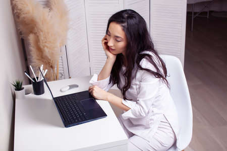 young pretty asian woman in white form working in clinic with laptop, lifestyle working people...