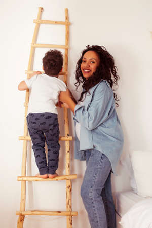 mixed raraces happy family, african american mother with caucasian son together at home, lifestyle...