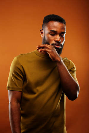 young pretty african american man posing cheerful on brown background, lifestyle people conceptの写真素材