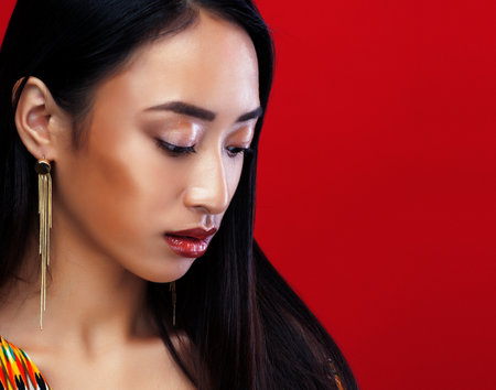 beauty young asian girl with fashion make up on red background , beauty stylish lookの写真素材