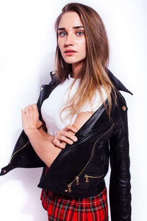 young pretty stylish hipster girl in leather jacket and school shirt posing emotional isolated on white background happy smiling cool smile, lifestyle people conceptの写真素材