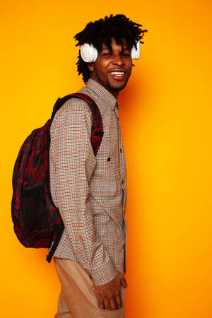 young handsome african american guy student posing cheerful and gesturing on yellow background, lifestyle people conceptの写真素材