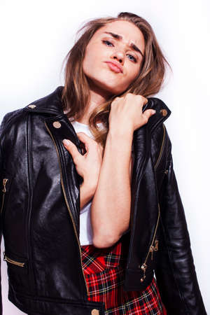 young pretty stylish hipster girl in leather jacket and school shirt posing emotional isolated on...