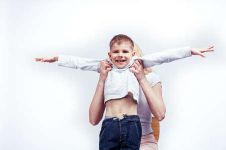 young modern blond curly mother with cute son together happy smiling family posing cheerful on white background, lifestyle people concept, sister and brother friendsの写真素材