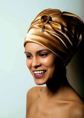 beauty african woman in shawl on head, very elegant look with gold jewelry close up mulatto makeupの写真素材