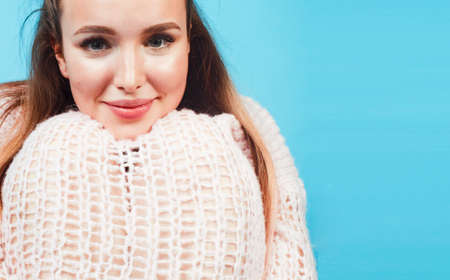 young pretty teenage modern hipster girl posing emotional happy on blue background, lifestyle people...