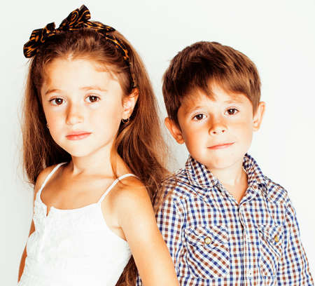 little cute boy and girl hugging playing on white background, happy family close up isolated, lifestyle people conceptの写真素材