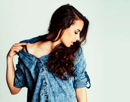 young pretty teenage hipster girl posing emotional happy smiling on white background, lifestyle people conceptの写真素材