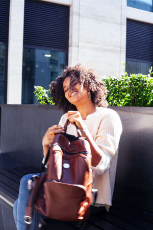 young pretty african girl posing cheerful on city background, lifestyle outdoor people conceptの写真素材
