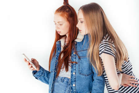 best friends teenage girls together having fun, posing emotional on white background, besties happy smiling, lifestyle people conceptの写真素材