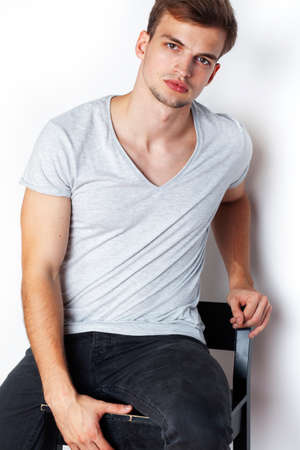 young handsome teenage hipster guy posing emotional, happy smiling against white background...