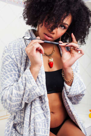 beauty young african american woman in bathrobe with tooth brush taking morning care of herself, lifestyle people conceptの写真素材