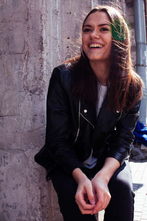 young pretty girl outside in city street happy smiling, lifestyle fashion peopple conceptの写真素材