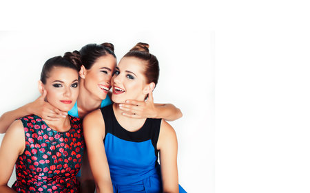group of diverse stylish ladies in bright dresses isolated on white smiling having fun, watching...
