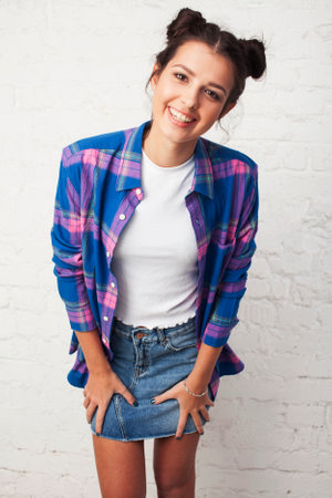 young pretty stylish hipster girl posing emotional isolated on white background happy smiling cool smile, lifestyle people conceptの写真素材