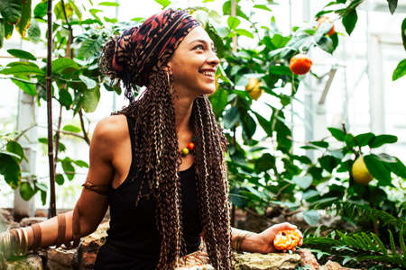 Young cute smiling woman in park with oranges, lifestyle concept green spring